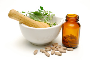 medicinal herbs and tablets on white background